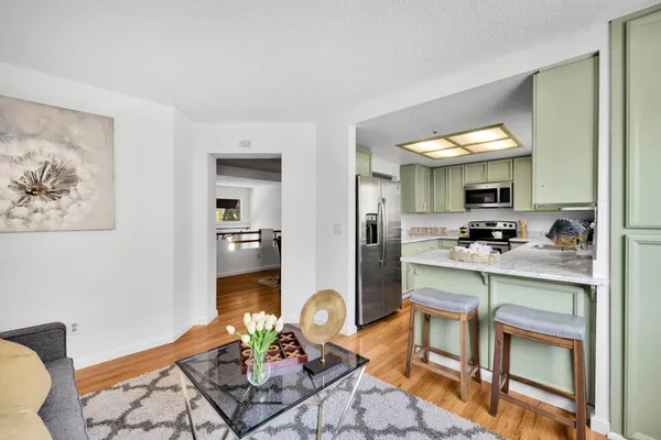 a kitchen with stainless steel appliances granite countertop a refrigerator and a stove
