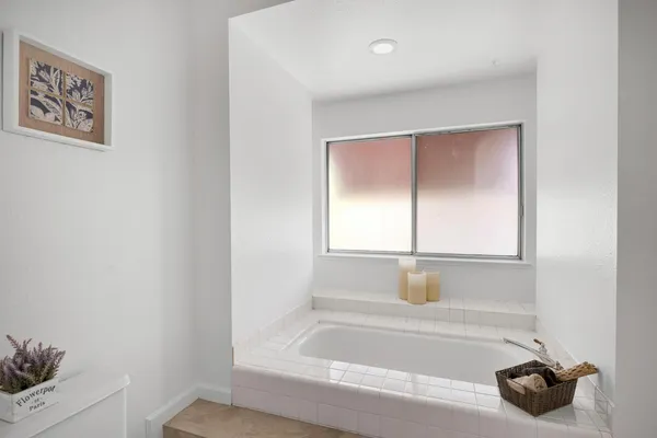a bathroom with a tub and a window