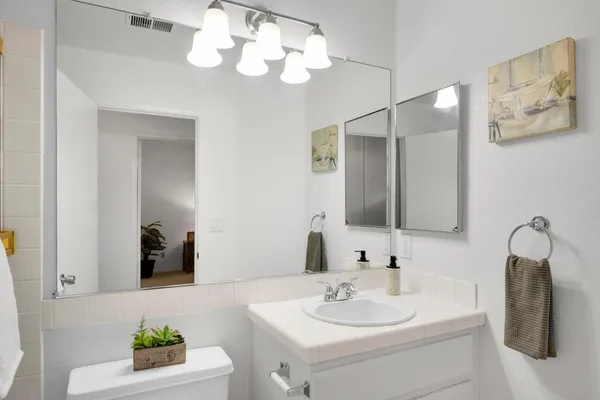 a bathroom with a sink a mirror and vanity