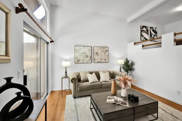 a living room with furniture and wooden floor