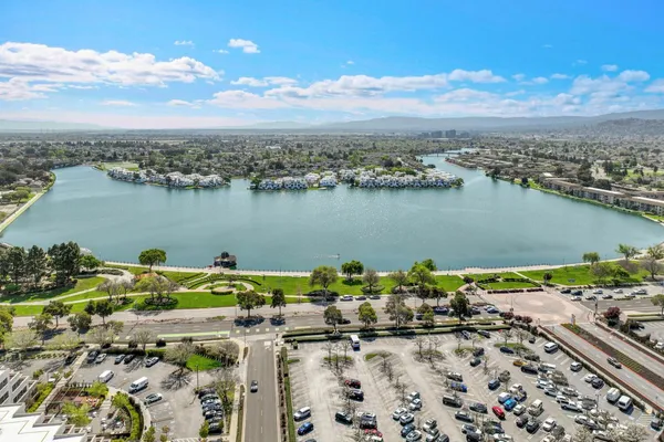 an aerial view of a houses with a lake