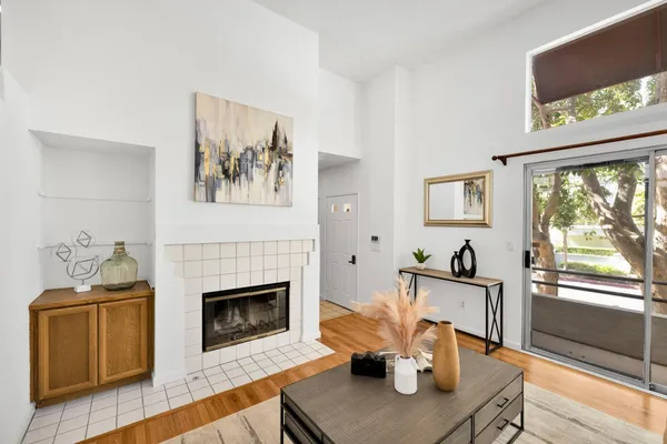 a living room with furniture a fireplace and a flat screen tv