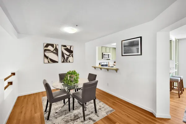 a view of a dining room with furniture and wooden floor