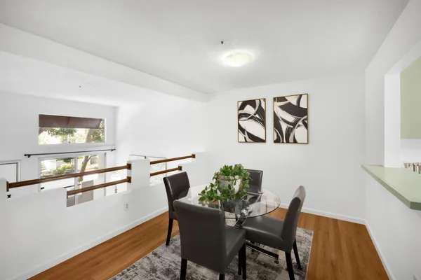 a view of a dining room with furniture and wooden floor