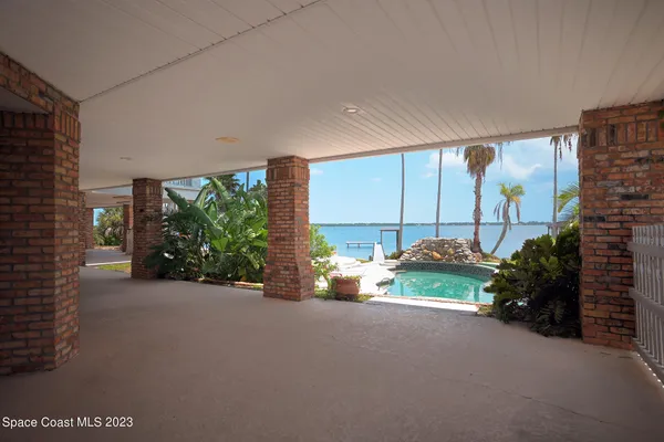 a view of a building with a yard and potted plants