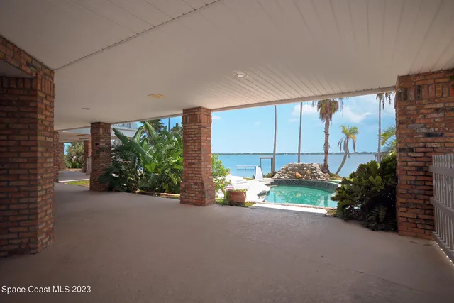 a view of a building with a yard and potted plants
