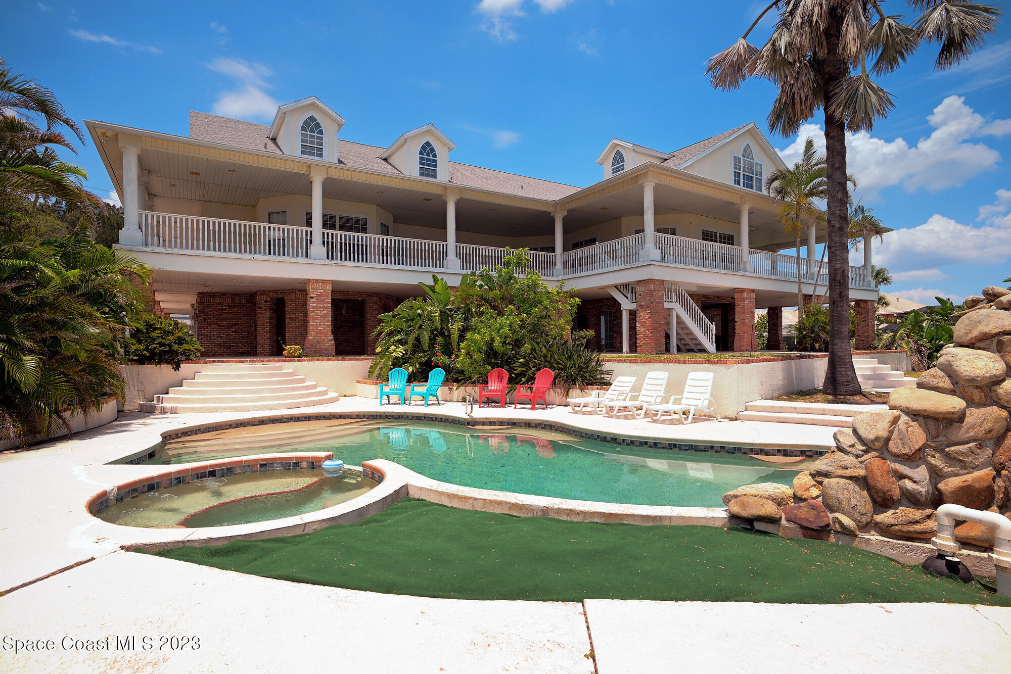 6285 N Highway Melbourne, FL 32940 - Photo 25 of 58 a swimming pool with outdoor seating and yard