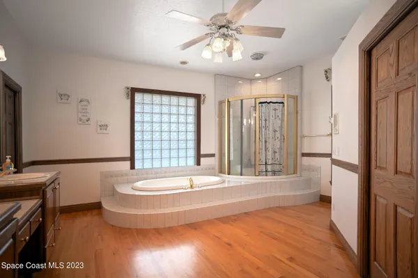 a bedroom with two large bed and a chandelier