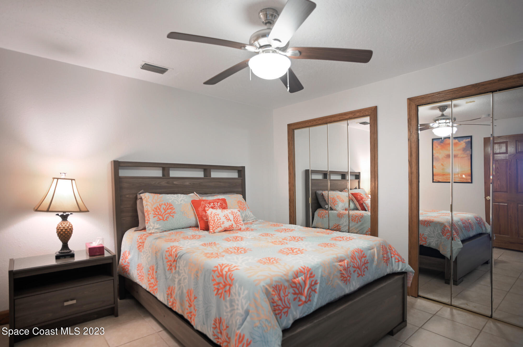 6285 N Highway Melbourne, FL 32940 - Photo 42 of 58 a bedroom with a bed and a chandelier