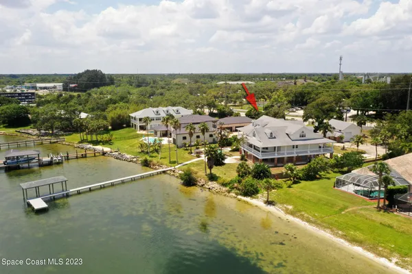 a living room with stainless steel appliances kitchen island granite countertop a stove a sink and dishwasher with wooden cabinets