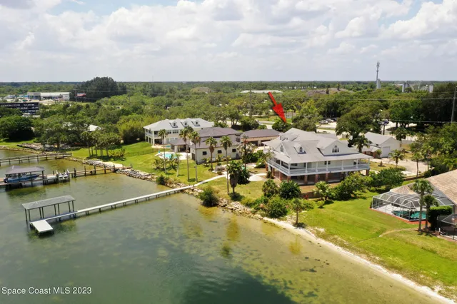 a living room with stainless steel appliances kitchen island granite countertop a stove a sink and dishwasher with wooden cabinets