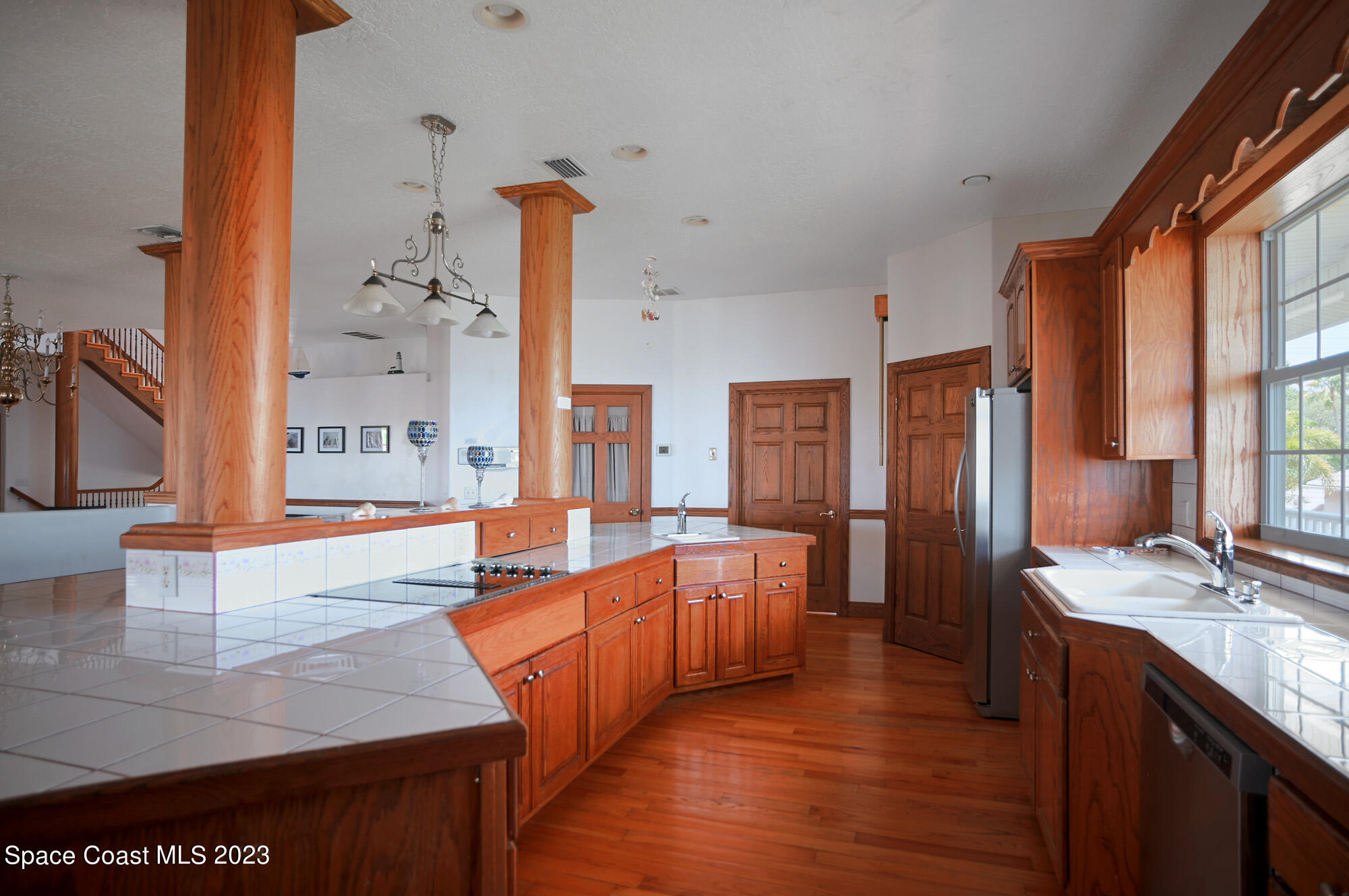 6285 N Highway Melbourne, FL 32940 - Photo 9 of 58 a large kitchen with stainless steel appliances wooden floor and a large window