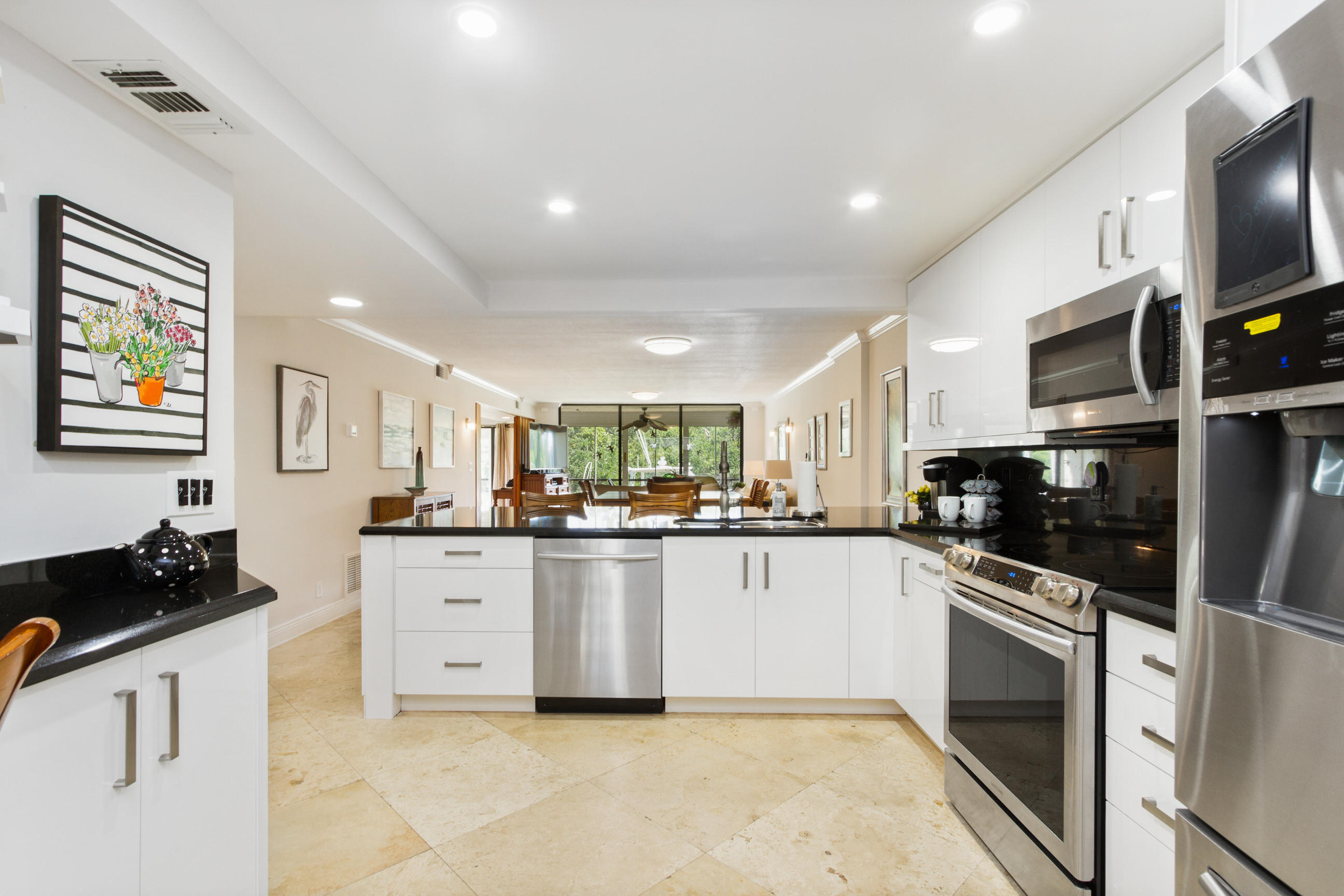 a kitchen with stainless steel appliances a stove sink microwave and cabinets