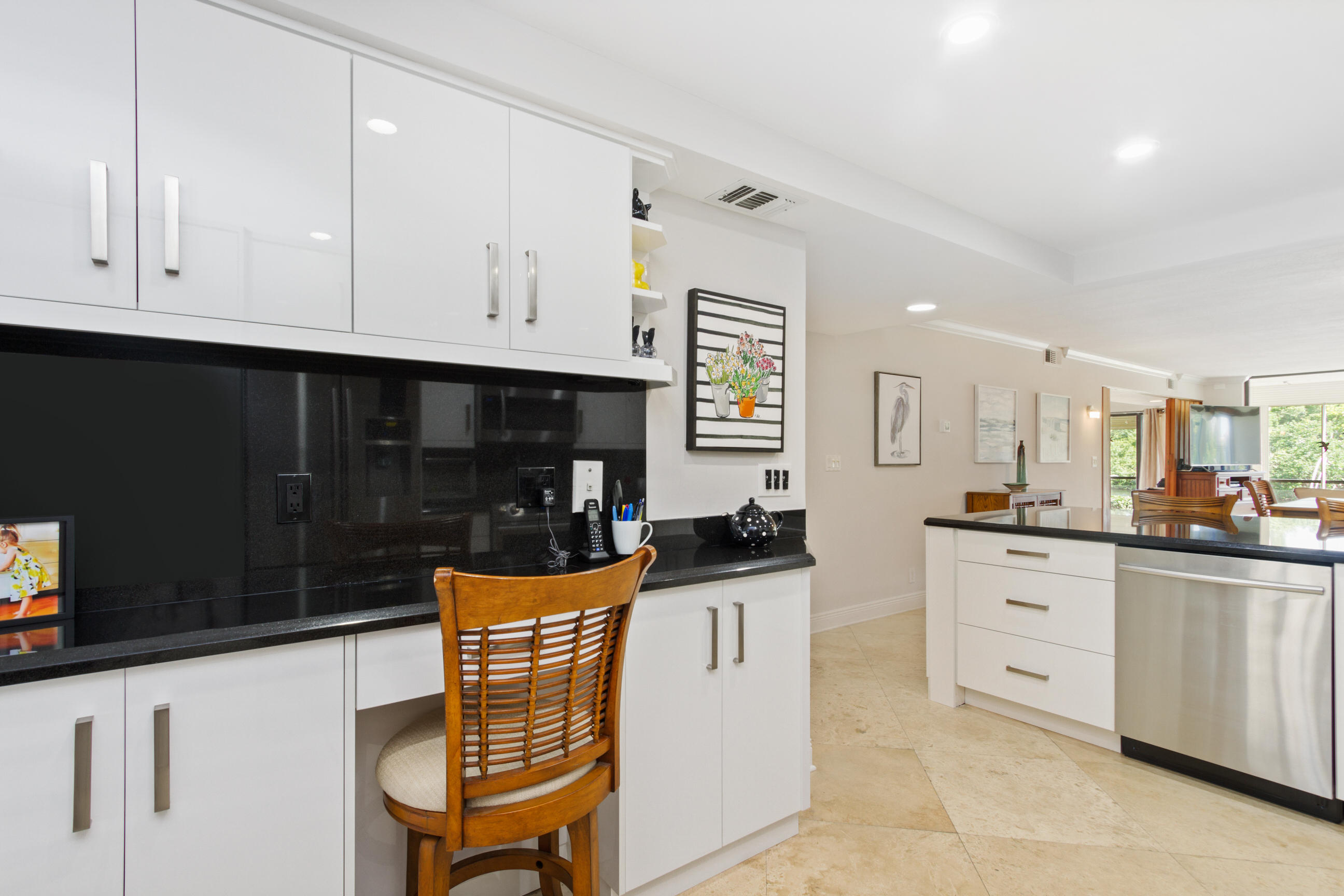 1631 Riverview Road, Unit 102 Deerfield Beach, FL 33441 - Photo 10 of 37 a kitchen with granite countertop white cabinets and white appliances