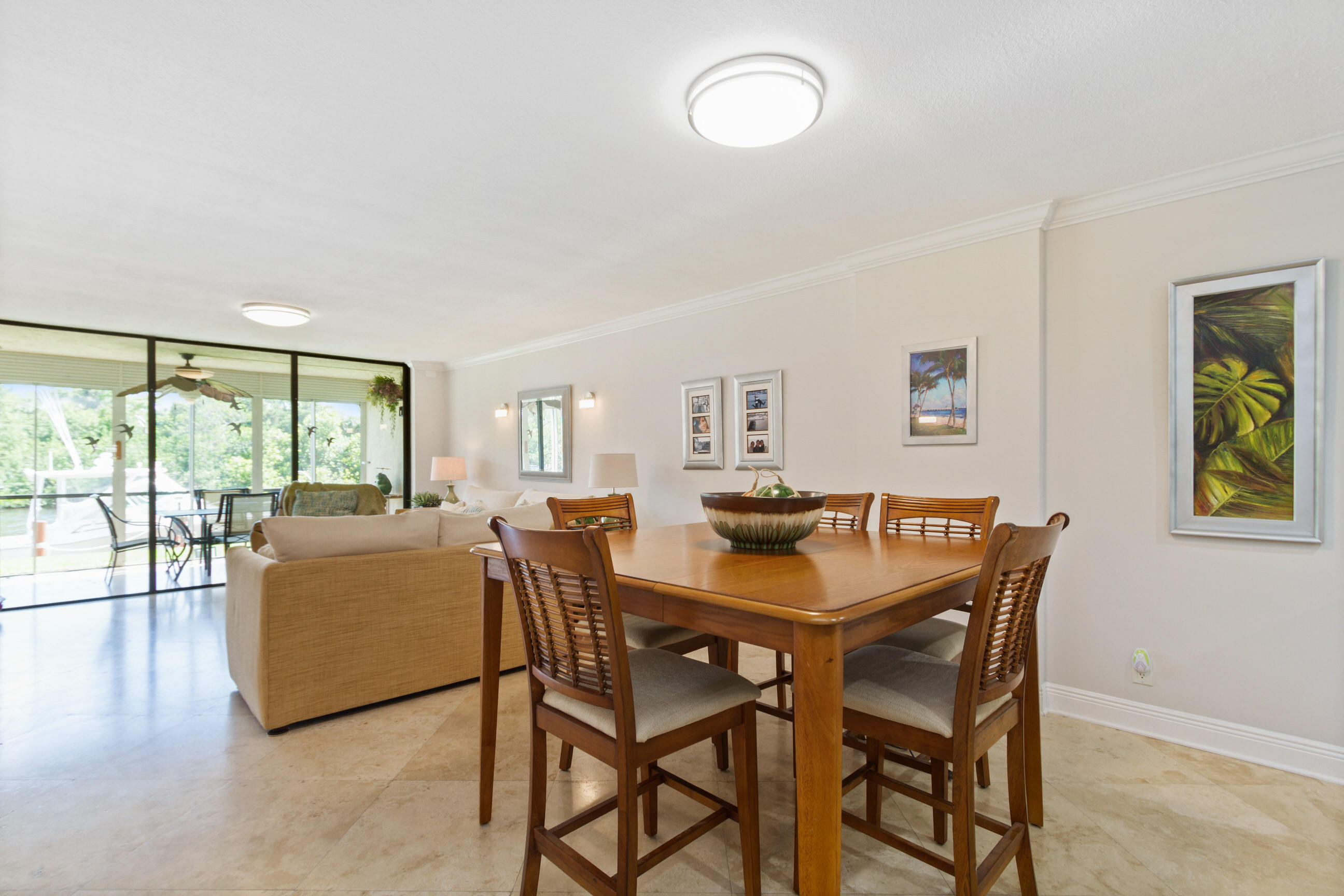 1631 Riverview Road, Unit 102 Deerfield Beach, FL 33441 - Photo 12 of 37 a dining room with furniture and wooden floor