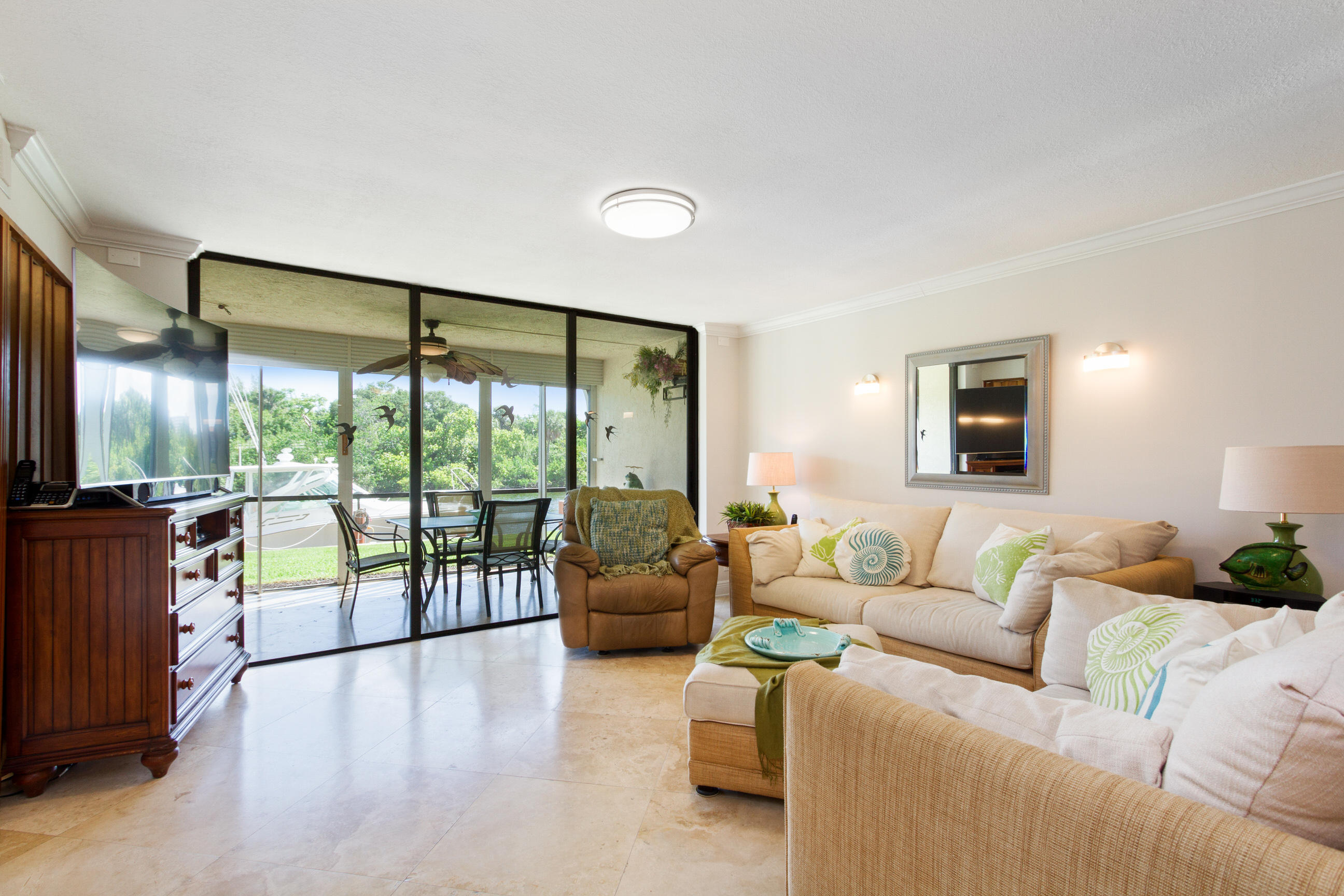 1631 Riverview Road, Unit 102 Deerfield Beach, FL 33441 - Photo 13 of 37 a living room with furniture and a large window