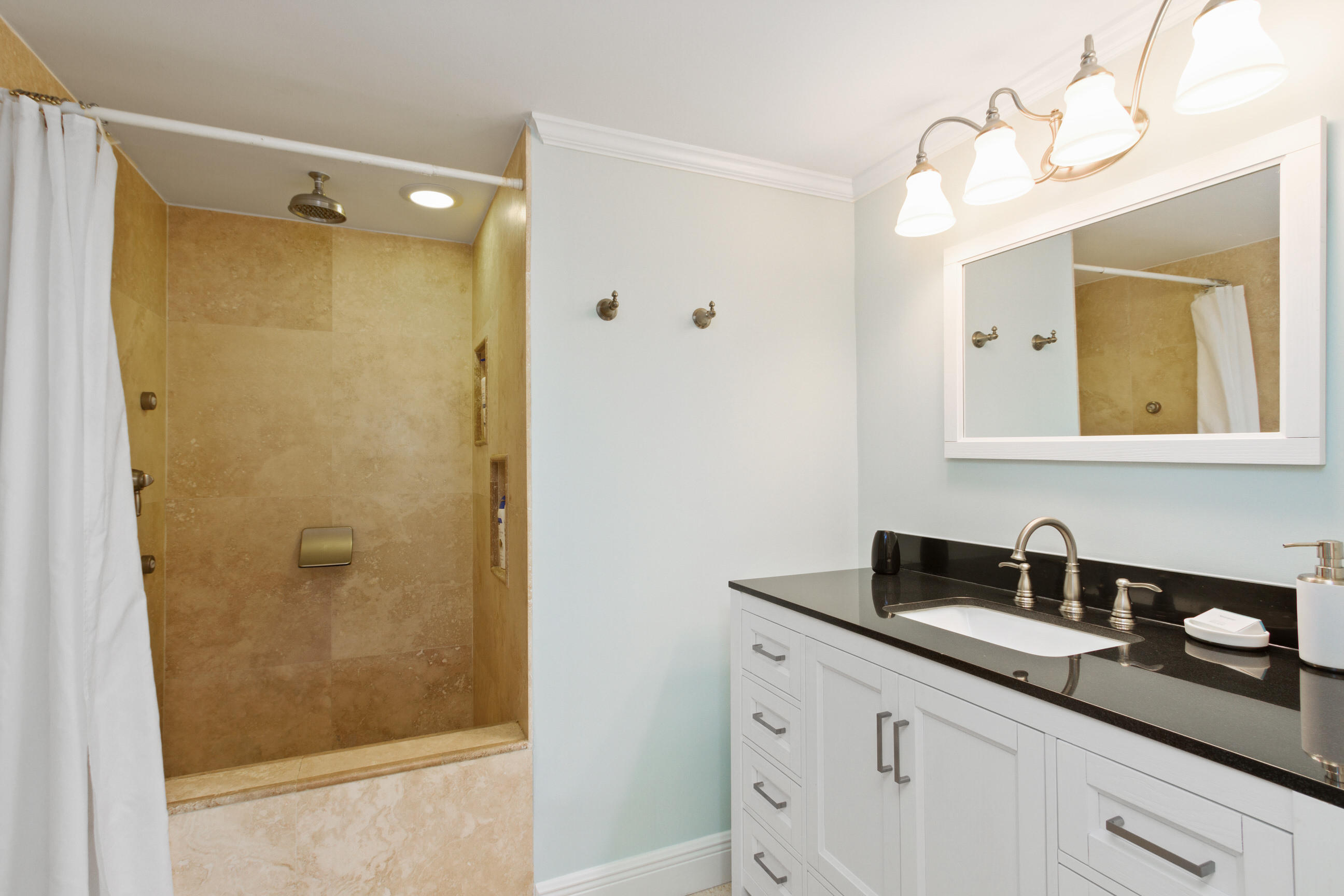 1631 Riverview Road, Unit 102 Deerfield Beach, FL 33441 - Photo 18 of 37 a bathroom with a shower sink and mirror