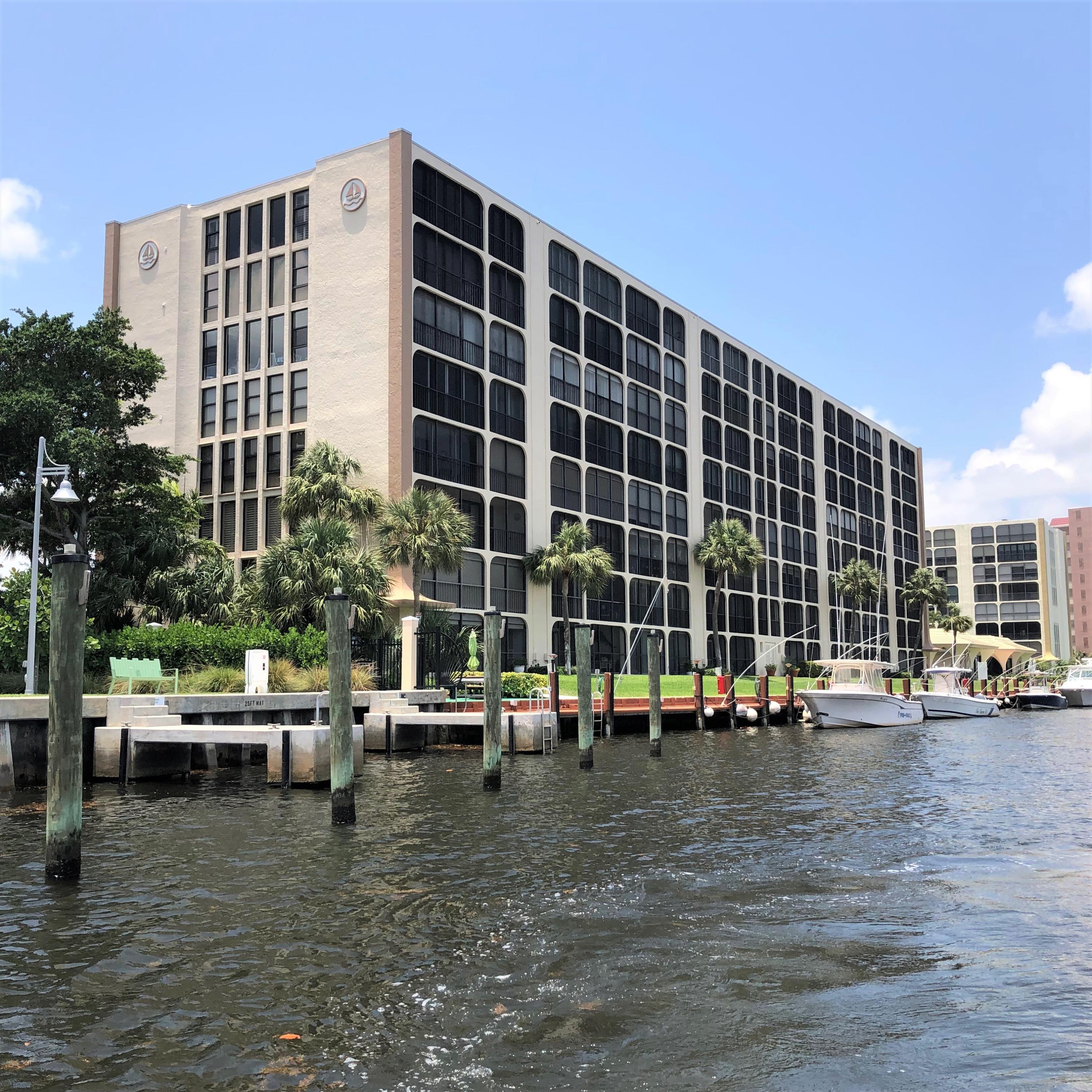 1631 Riverview Road, Unit 102 Deerfield Beach, FL 33441 - Photo 25 of 37 a view of a building with cars parked