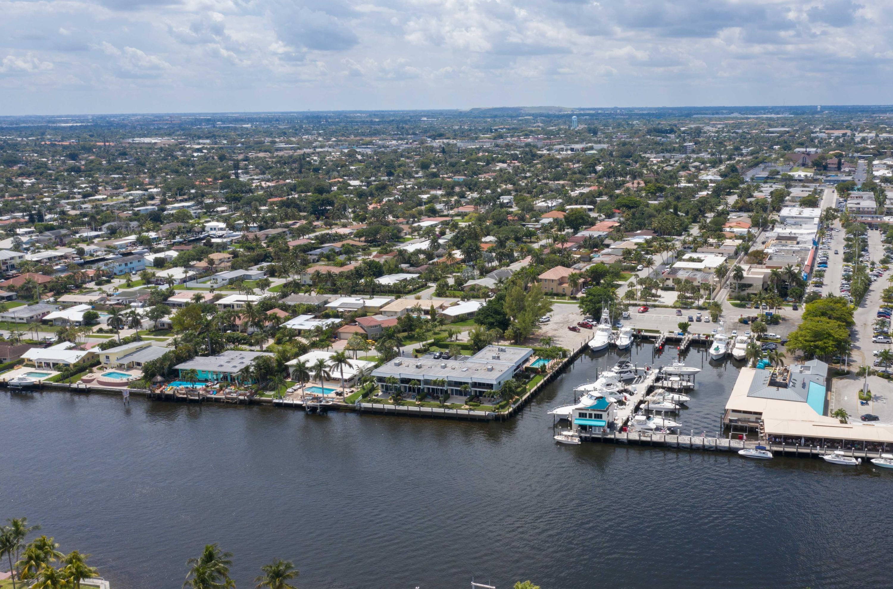 1631 Riverview Road, Unit 102 Deerfield Beach, FL 33441 - Photo 32 of 37 an aerial view of residential houses with outdoor space and trees