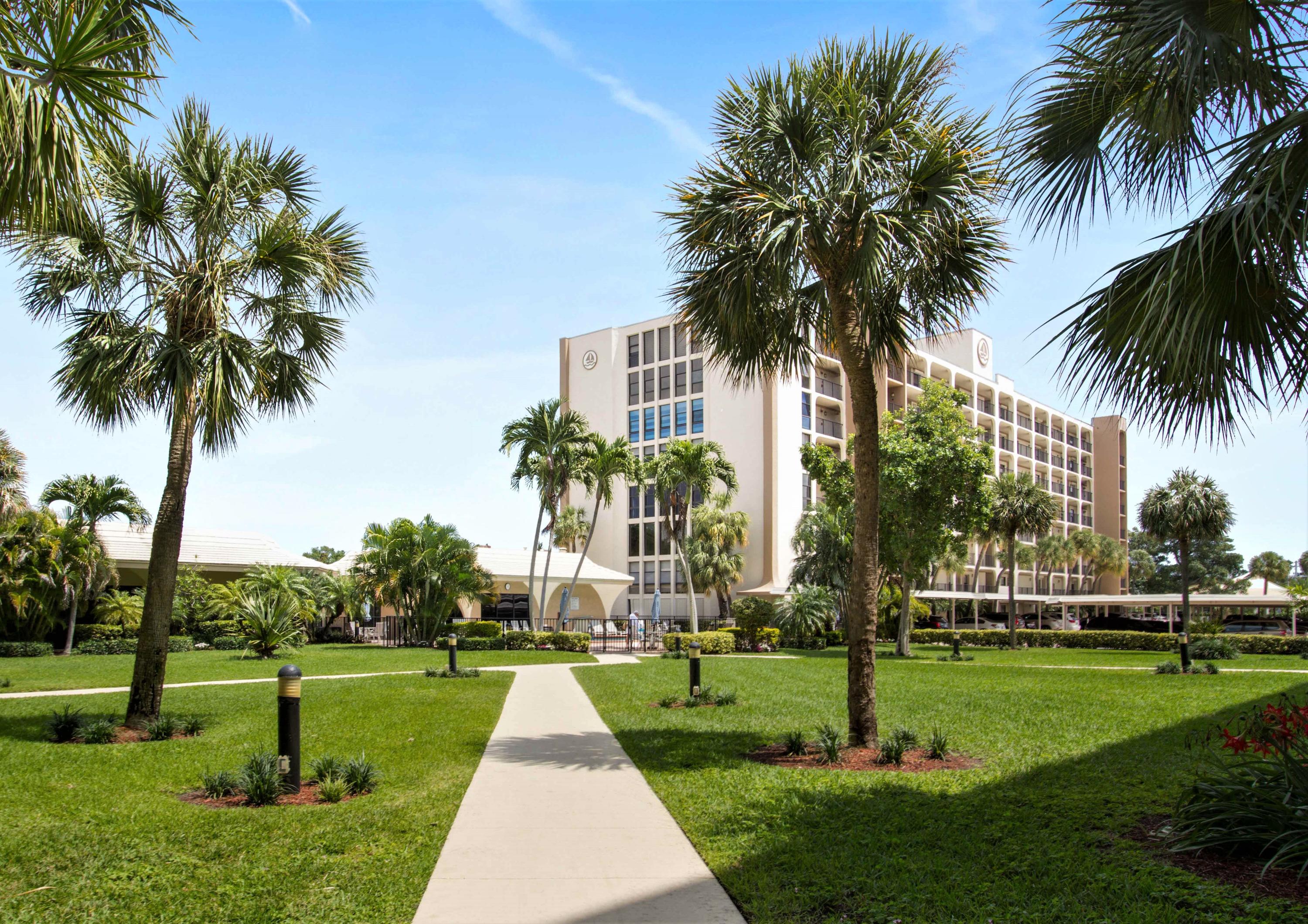 1631 Riverview Road, Unit 102 Deerfield Beach, FL 33441 - Photo 36 of 37 a front view of multi story residential apartment building with yard and green space