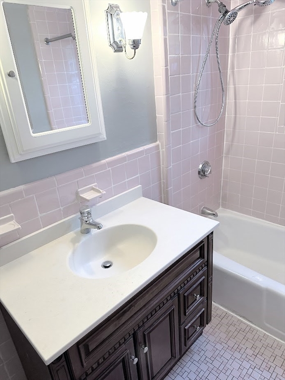 90 Boylston Street, Unit 1 Watertown, MA 02472 - Photo 7 of 16 a bathroom with a sink and a bathtub