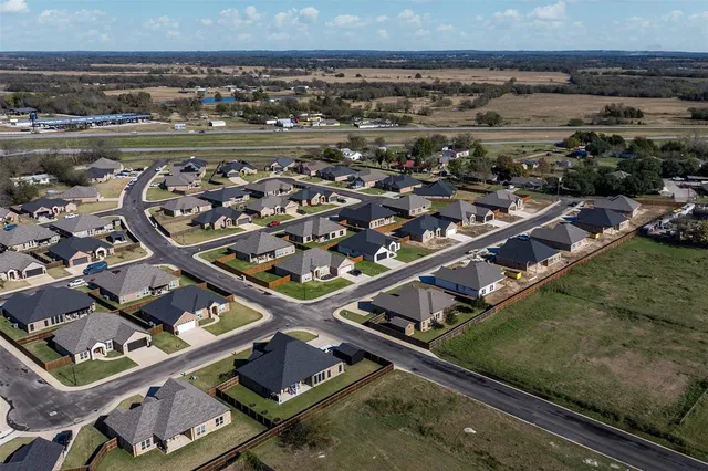 an aerial view of residential houses with outdoor space
