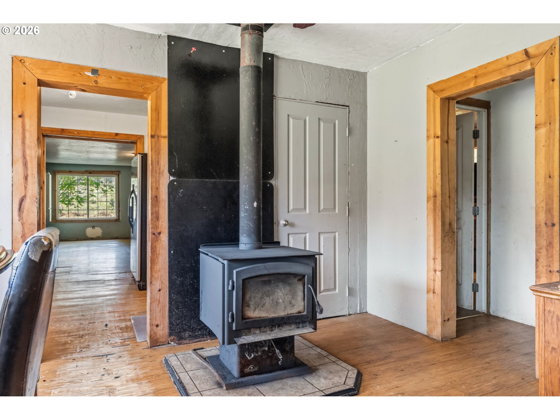 21542 Highway 126 Noti, OR 97461 - Photo 13 of 22 a view of a bedroom with wooden floor and a fireplace