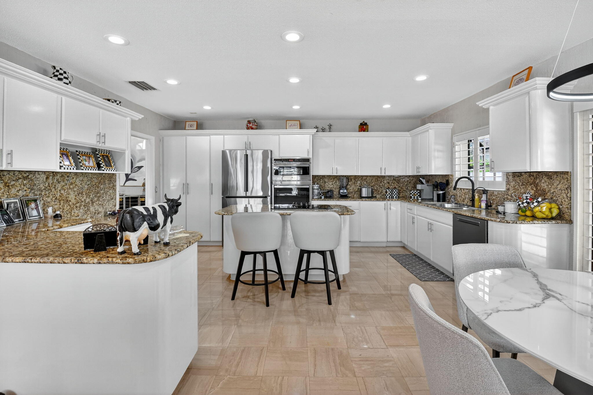 7336 Ballantrae Court Boca Raton, FL 33496 - Photo 11 of 32 a kitchen with stainless steel appliances kitchen island granite countertop a sink and cabinets