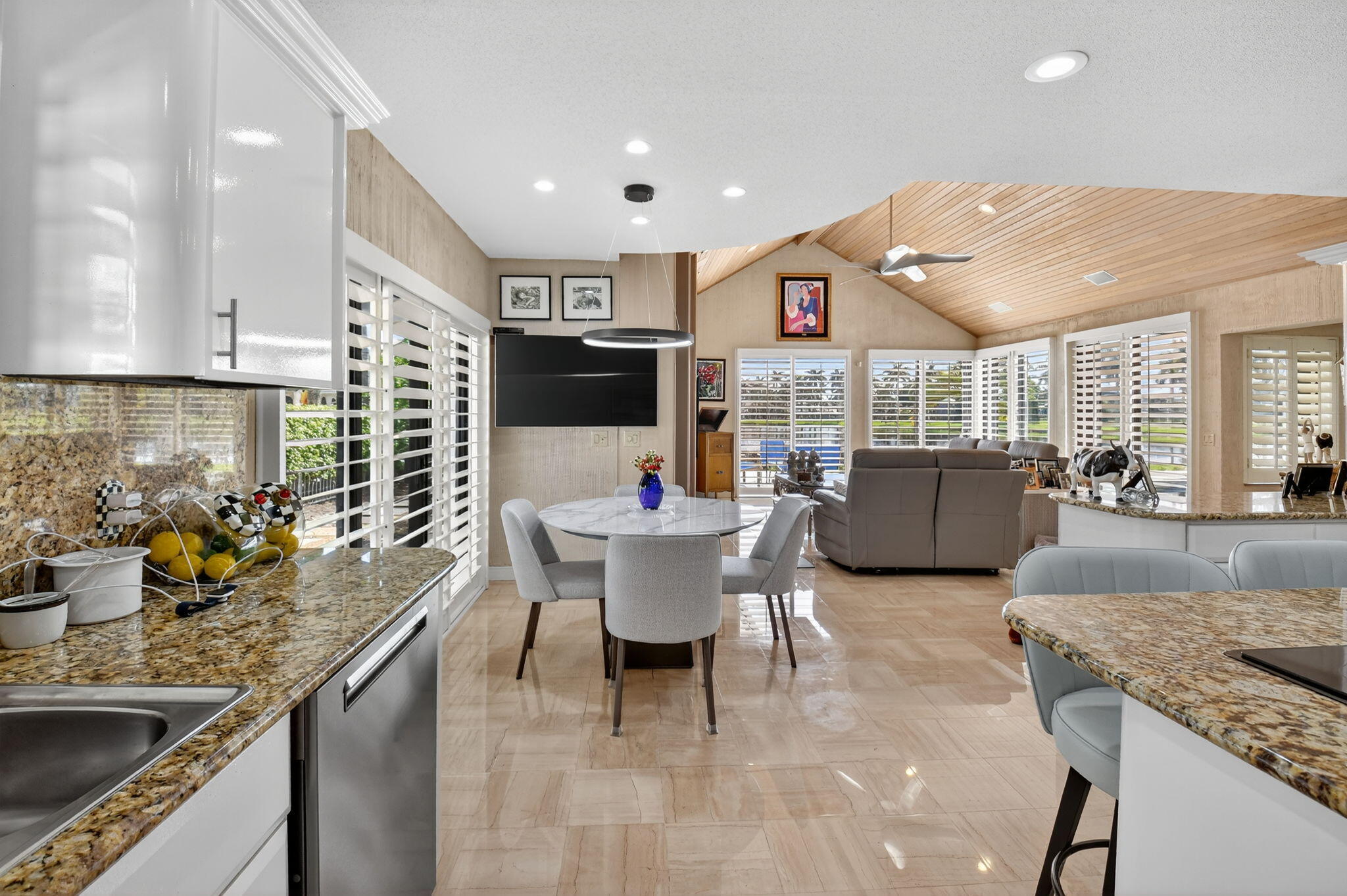 7336 Ballantrae Court Boca Raton, FL 33496 - Photo 13 of 32 a kitchen with a table chairs stove and cabinets