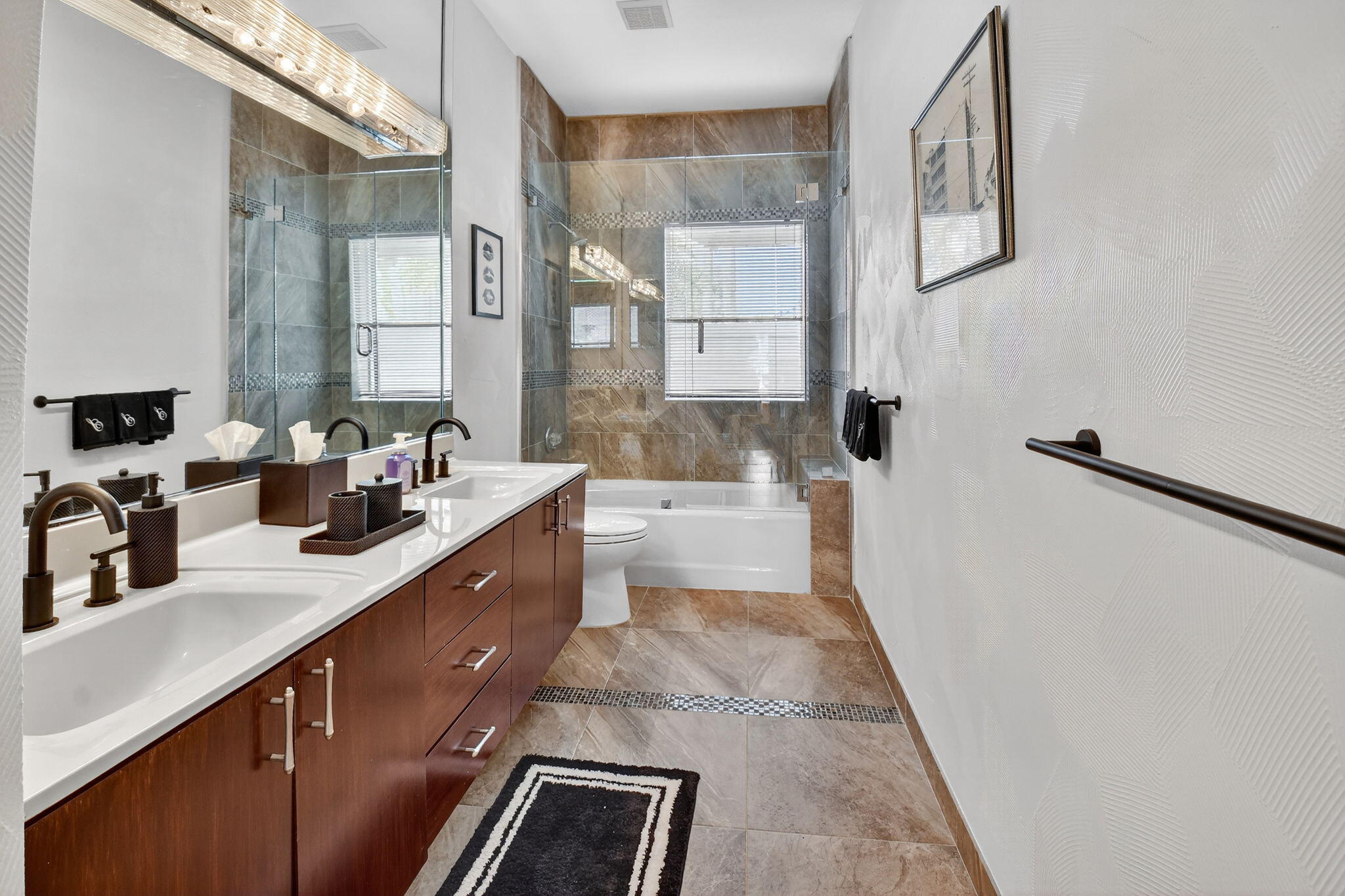 7336 Ballantrae Court Boca Raton, FL 33496 - Photo 22 of 32 a spacious bathroom with a double vanity sink a mirror and a bathtub
