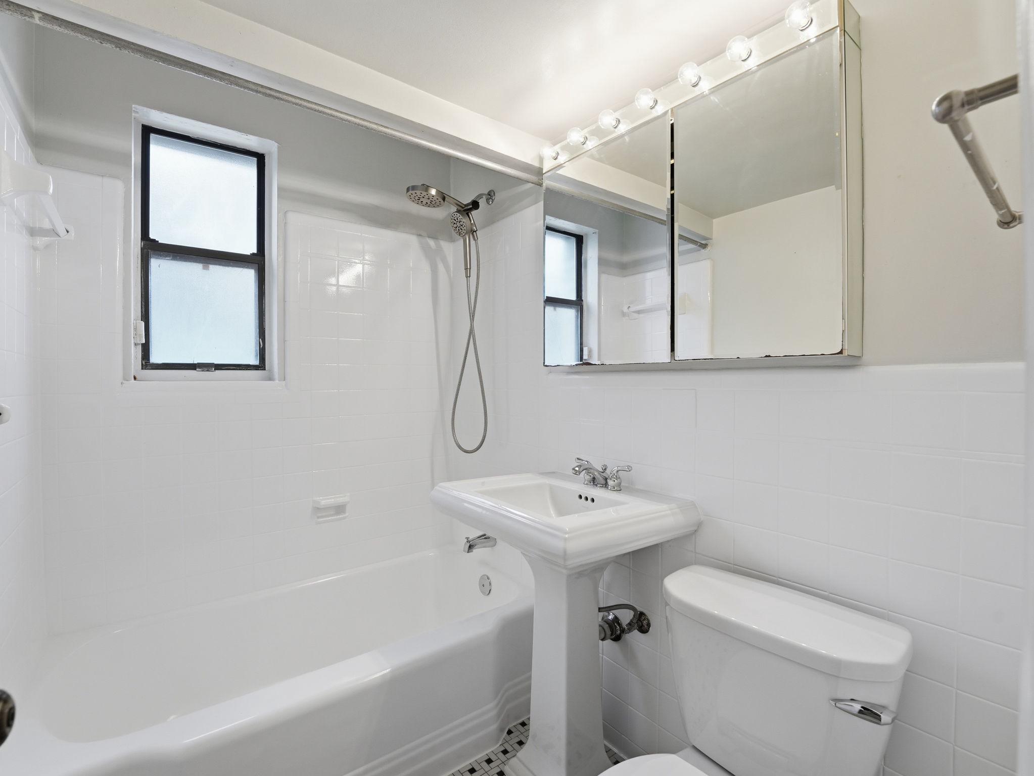 3835 Davis Place Northwest, Unit 2 Washington, DC 20007 - Photo 10 of 26 Tub & shower w/ pedestal sink & dble med cabinet.