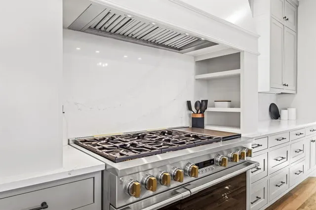 a stove top oven sitting inside of a kitchen
