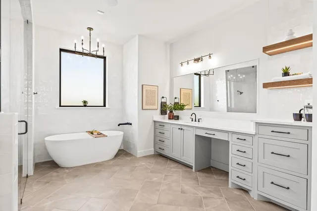 a spacious bathroom with a double vanity sink mirror and bathtub