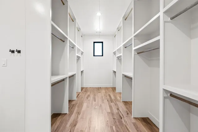 a view of hallway with wooden floor and staircase