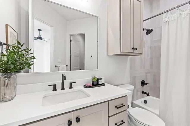 a bathroom with a sink a toilet and vanity