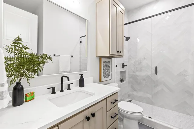 a bathroom with a sink toilet and shower