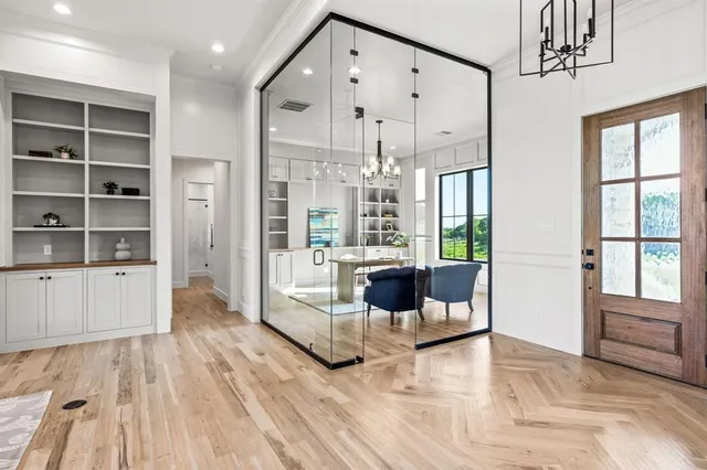 a view of a living room and entry way to room with wooden floor