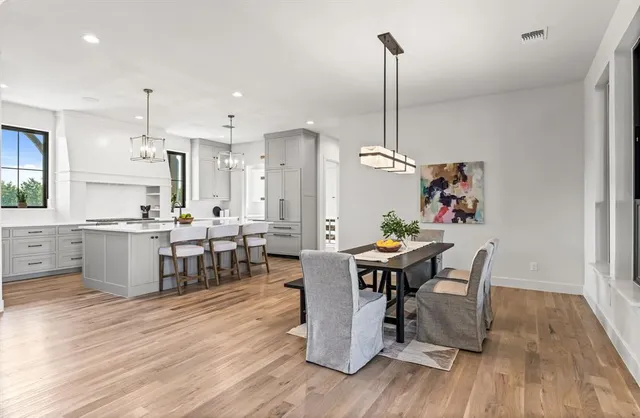 a view of a dining room with furniture wooden floor and chandelier
