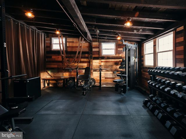 a room with gym equipment and a flat screen tv