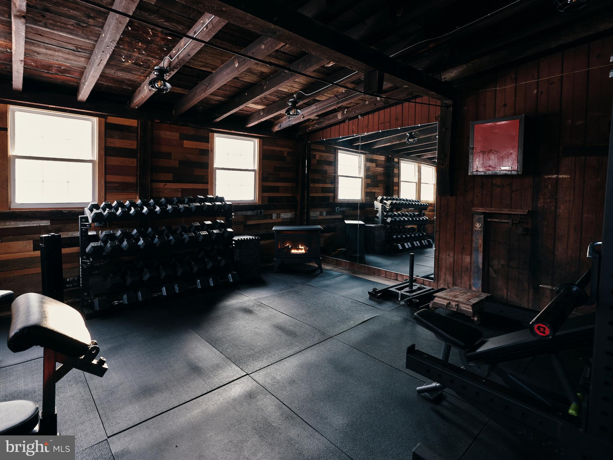 333 New Bethel Church Road Kempton, PA 19529 - Photo 17 of 48 a room with gym equipment and a flat screen tv