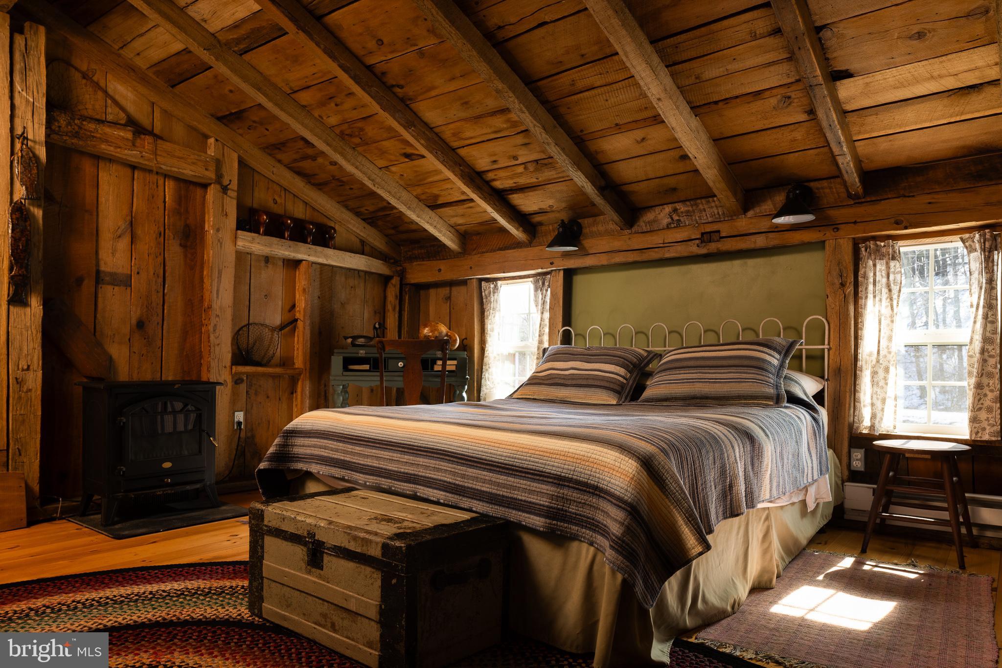 333 New Bethel Church Road Kempton, PA 19529 - Photo 36 of 48 a bed sitting in a bedroom next to a window