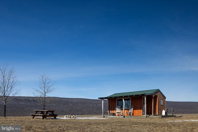 a backyard of a house with outdoor seating