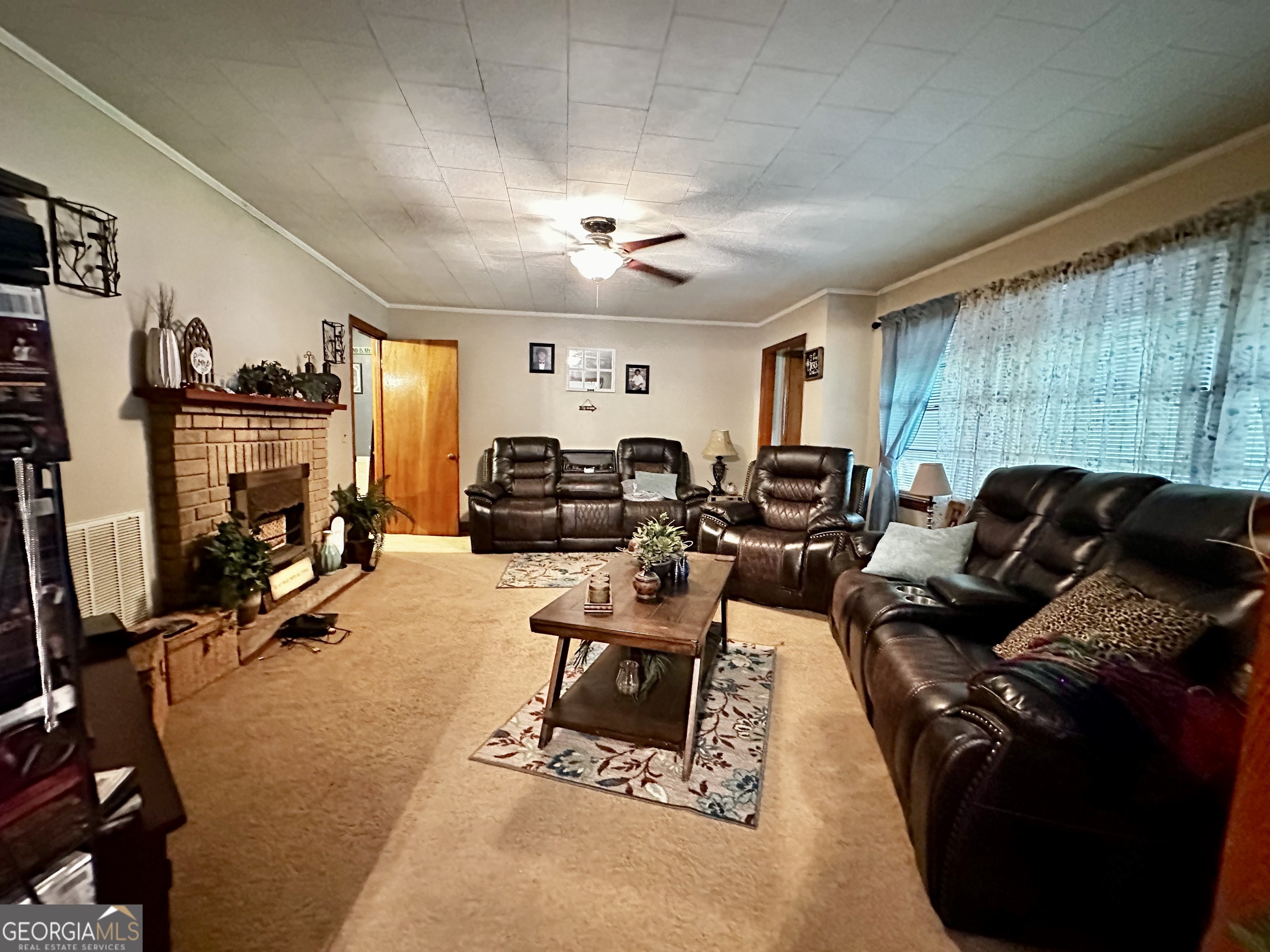 45 Mt Zion Street Milan, GA 31060 - Photo 16 of 27 a living room with furniture a large window and gym equipment