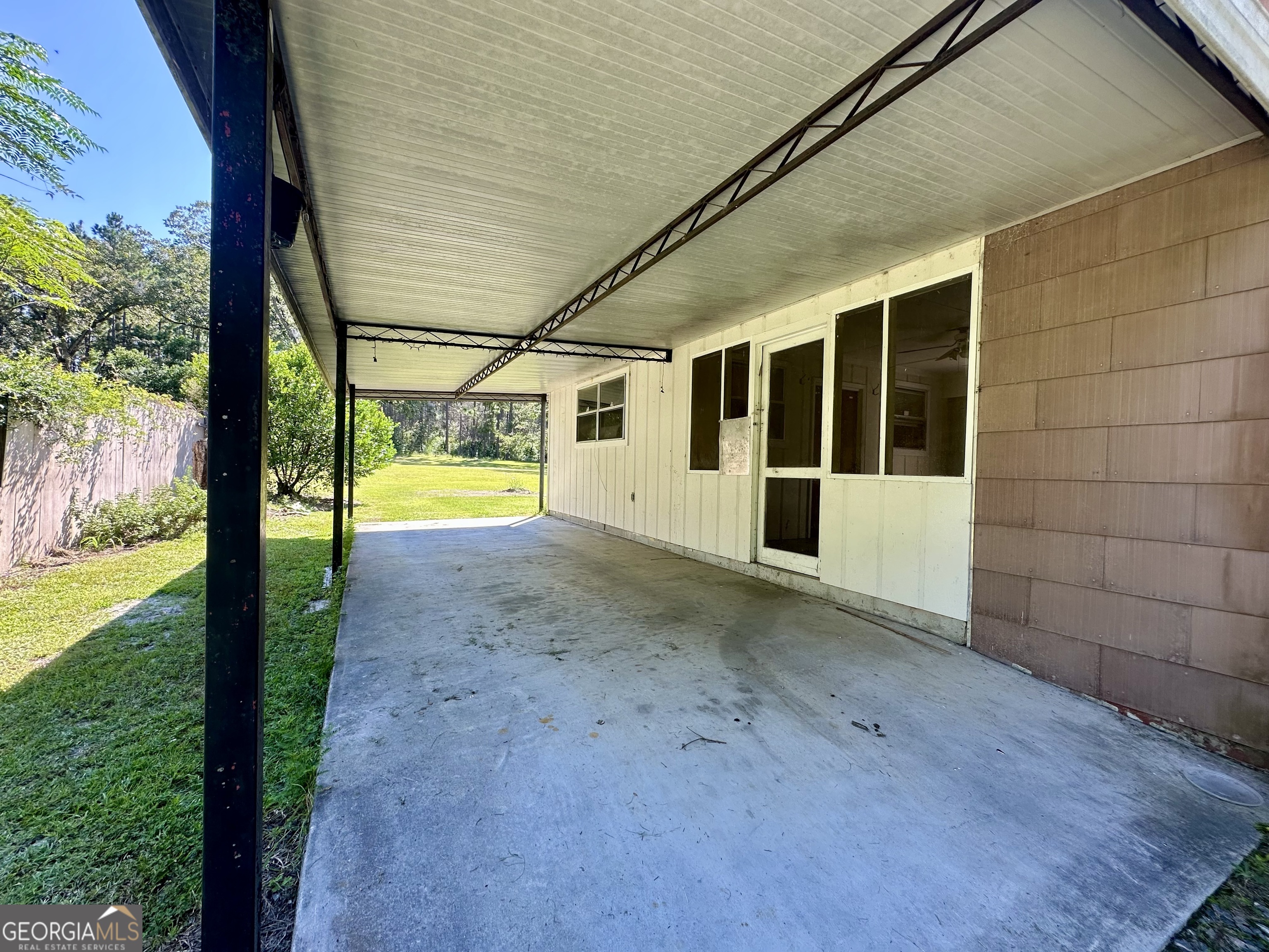 45 Mt Zion Street Milan, GA 31060 - Photo 17 of 27 a view of an empty room with a yard