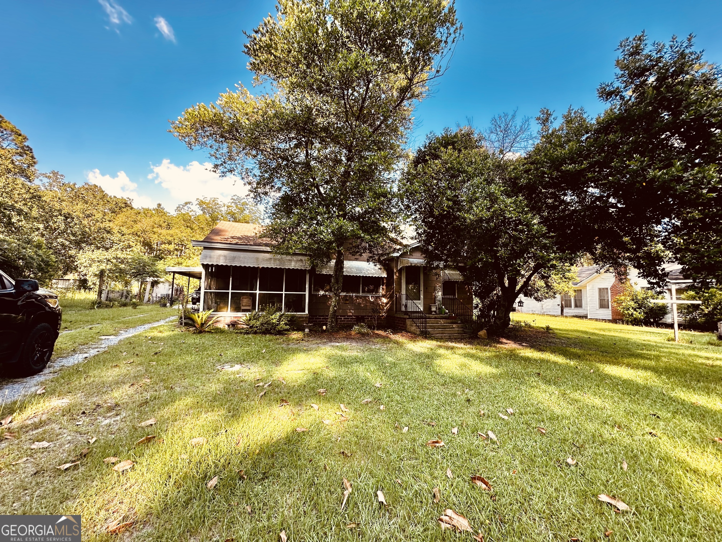 45 Mt Zion Street Milan, GA 31060 - Photo 2 of 27 a view of a yard with a house and large trees