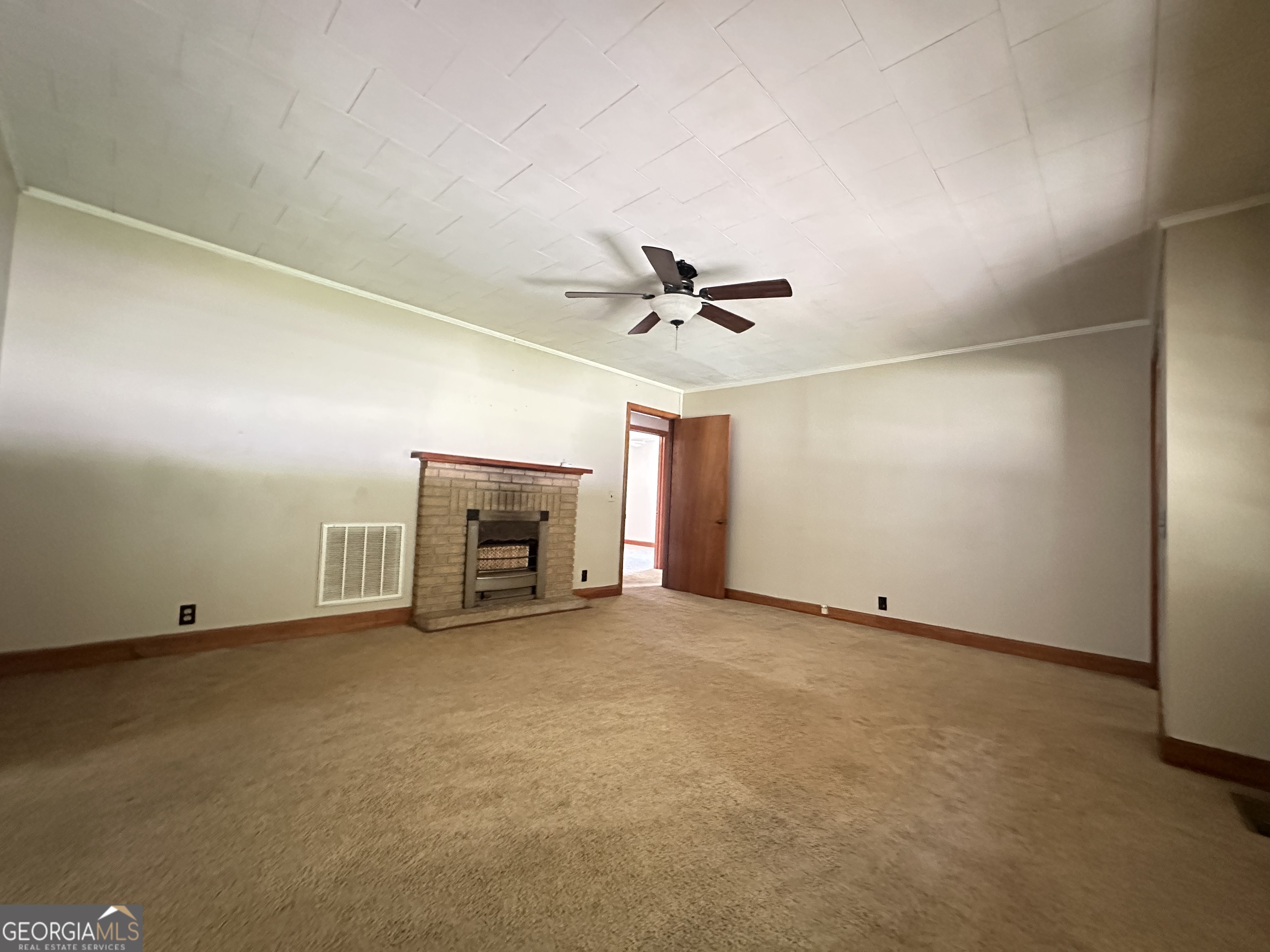 45 Mt Zion Street Milan, GA 31060 - Photo 21 of 27 a view of an empty room with a ceiling fan and window