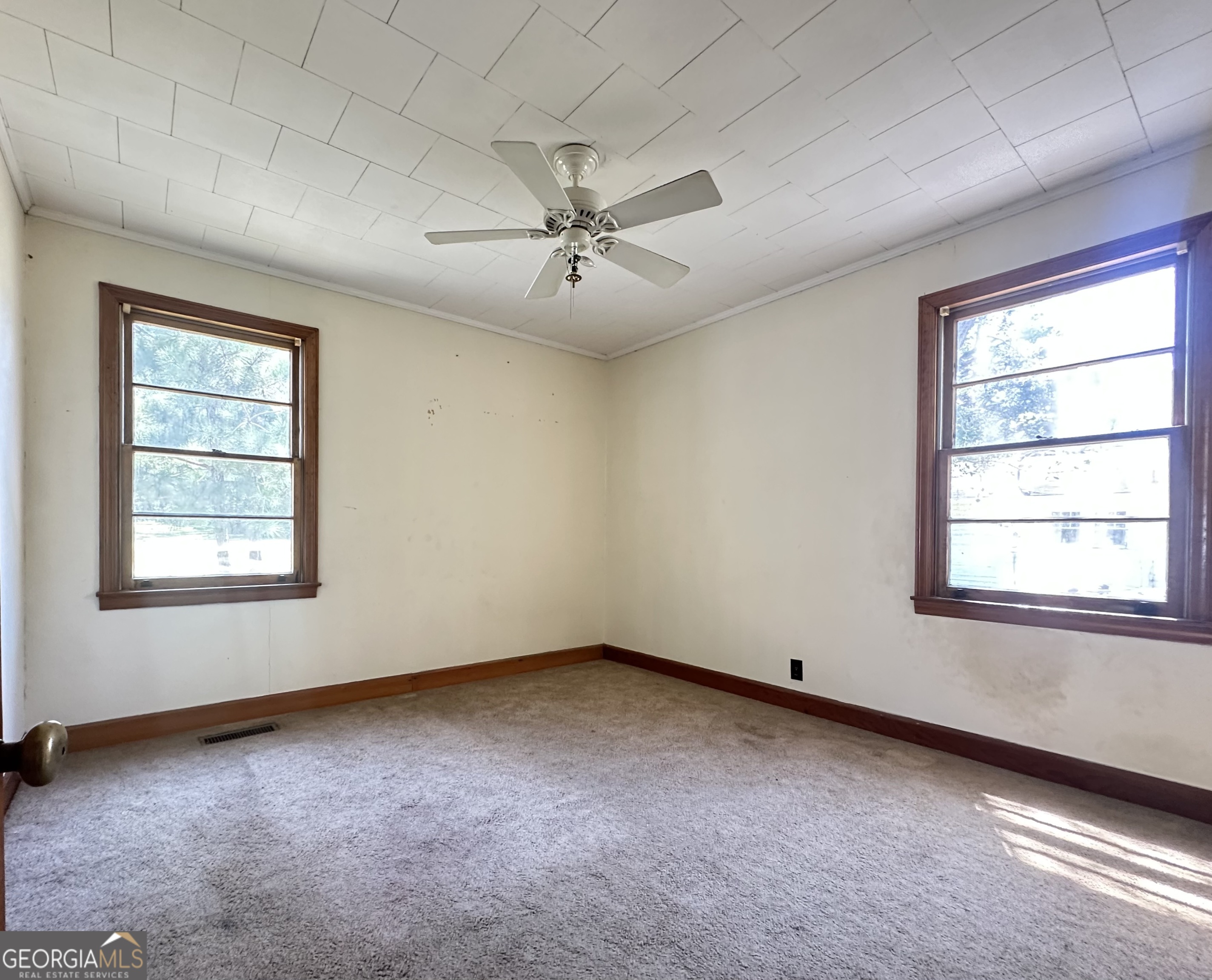 45 Mt Zion Street Milan, GA 31060 - Photo 25 of 27 an empty room with a window and ceiling fan