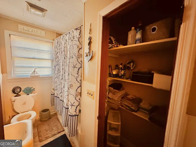 a bathroom with a bathtub and shower