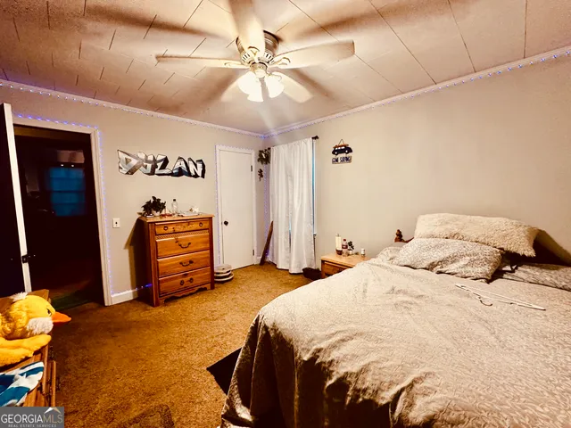 a bedroom with a bed and a ceiling fan