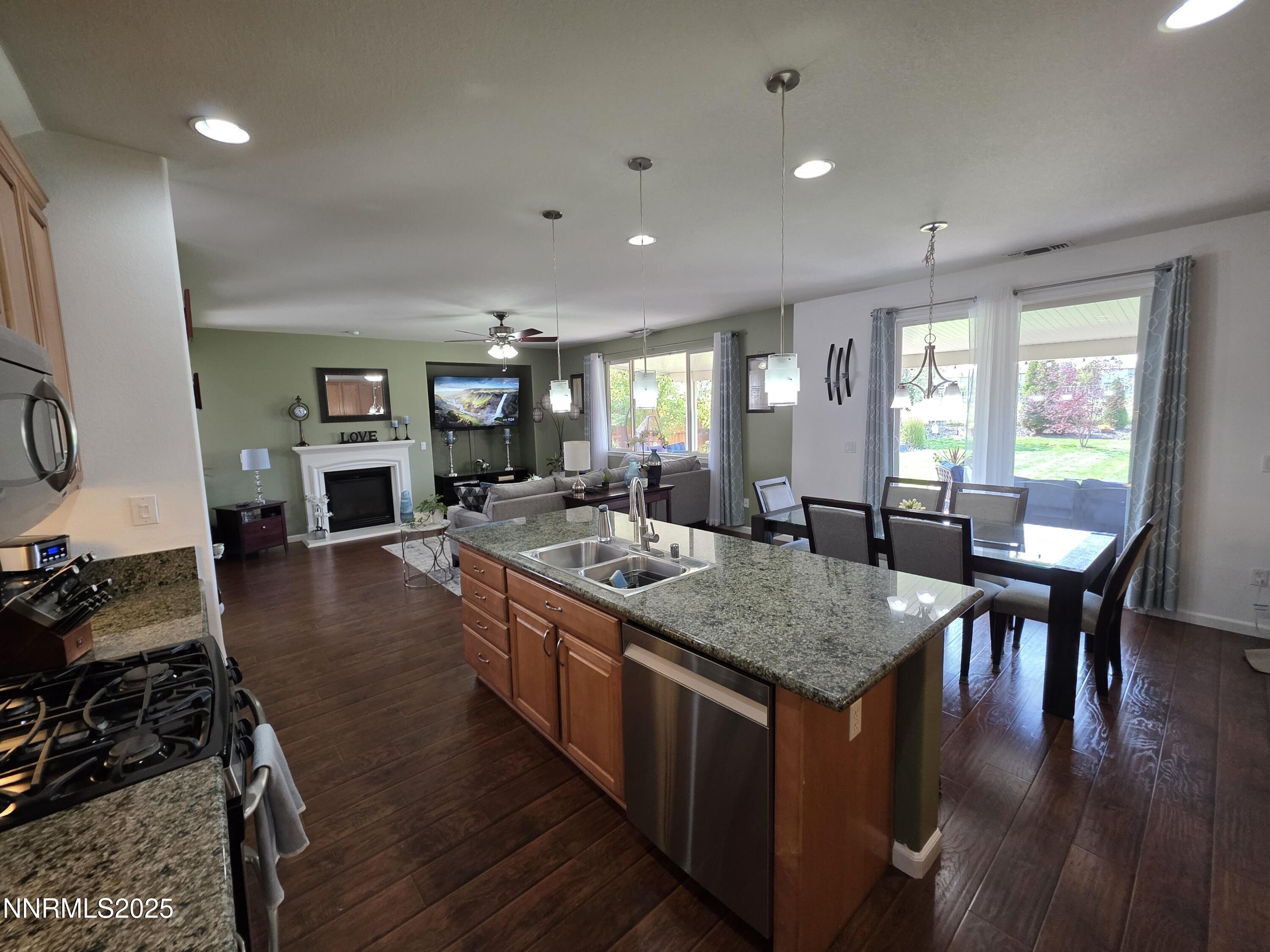 10677 Fire Poppy Circle Reno, NV 89521 - Photo 13 of 45 a kitchen with sink stove and dining table
